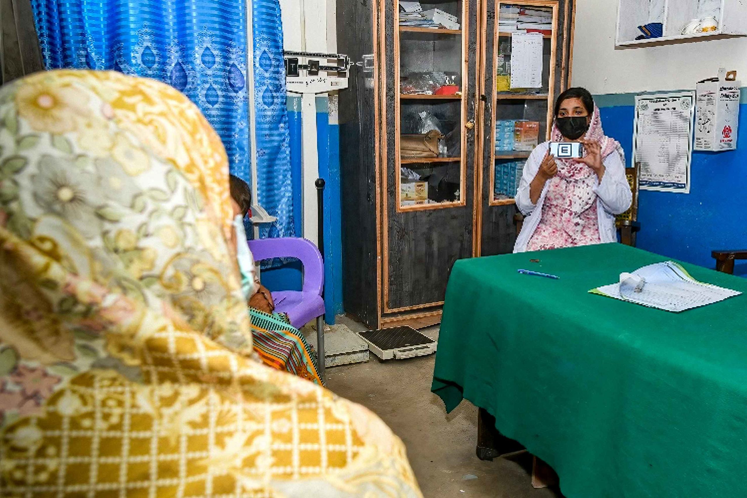 A lady health visitor tests visual acuity through Peek Acuity on an Android smartphone at a basic health unit in Chakwal district, Punjab, Pakistan. Photo Credit: CBM